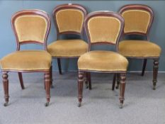 Set of four Victorian balloon back dining chairs with reeded front legs raised on brass castors