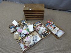 Oak chest of five drawers and sewing related contents including reels of thread scissors, fittings