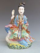 19th/20thC Chinese polychrome figurine astride a bird holding a scroll in its beak, height 27cm