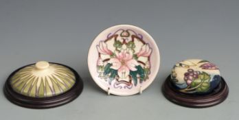 Moorcroft pin dish dated 2001 and two Moorcroft paperweights, diameter 13.5cm