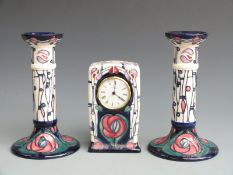 Moorcroft clock and candlestick garniture in the Mackintosh pattern, tallest 21cm