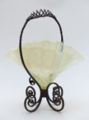 Vaseline glass handkerchief centre piece mounted on a wrought iron frame in the form of a basket,