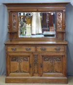 Art Nouveau oak sideboard with bevelled mirror back flanked by embossed hammered copper panels,