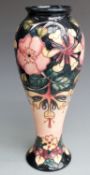 Moorcroft signed pedestal vase decorated with flowers and dated 1993, boxed, H28cm