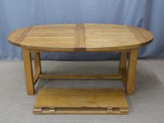 A contemporary light oak oval dining table with two additional leaves, max L 272 min 192 x W110 x