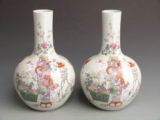 A pair of Chinese bulbous pedestal vases with floral, bat and peony decoration and Qianlong mark