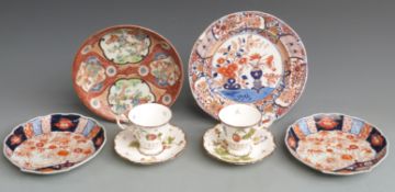 Pair of Coalport cabinet cups and saucers decorated with fruit and insects and four Japanese Imari