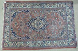 Two wool rugs both on red grounds, larger 190x140cm