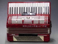 Weltmeister Amigo 120 bass piano accordion with 5 treble and 3 bass couplers in red pearloid finish,