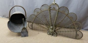 A copper coal scuttle and a peacock fan collapsible fire guard