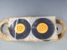 Approximately 40 singles, mostly Elvis Presley, in a retro purse style carry case