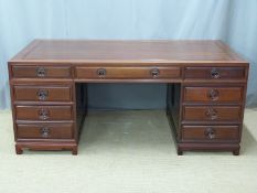 Chinese carved elm twin pedestal desk with an arrangement of nine drawers and dummy arrangement to