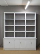 Modern white shelf unit with cupboards below, W200 x D47 x H230cm