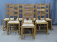 Eight contemporary light oak dining chairs with rush seats