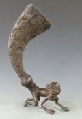 Ashanti 19thC bronze figural horn libation cup, the carved horn attached to an African figure,