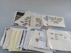 A selection of QEII Commonwealth stamps on loose album sheets and including high value sets