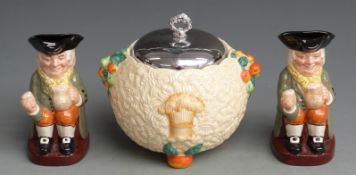 A Clarice Cliff Celtic Harvest biscuit pot with chromed lid together with two Royal Doulton Toby
