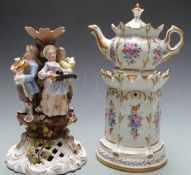 A continental porcelain chocolate pot on pastille burner stand and a porcelain figural group