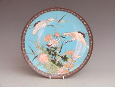 A 19thC Japanese cloisonné charger with crane and floral decoration, diameter 30.5cm