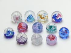Twelve Caithness glass paperweights including miniature and Collectors' Club editions with