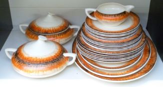 Clarice Cliff dinner ware decorated in the orange Aura pattern with Bizarre and Wilkinson pottery
