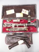 Pagot et Cie composite bodied clarinet stamped B, with spare reeds and some pre-decimal coins, in