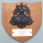 Cast iron fire mark insurance plaque with 'The Oxford' in raised script, mounted on oak shield