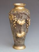Japanese bronze/ brass vase with grape and vine decoration in relief and mark to base, 38cm tall