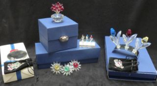 A collection of Swarovski Crystal cut glass flowers including three tulips, three daisy ring