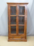 An Eastern hardwood bookcase with drawer under and decorative ironwork doors, W85 x D39 x H159cm