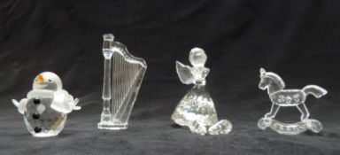 Four Swarovski Crystal cut glass items comprising Snowman 250229, Angel 194761, Harp 169245 and