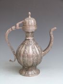 Persian/ Indian pedestal coffee pot with deep relief decoration of flowers, elephant trunk spout,
