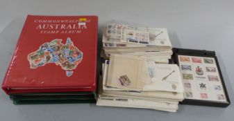 Three albums of Australia, New Zealand and Canada stamps together with Canada first day covers and
