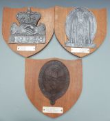 Three replica fire mark insurance plaques on oak shields with notes attached including Yorkshire
