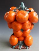 An unusual continental majolica jug in the form of a bunch of tangerines,the handle in the form of a