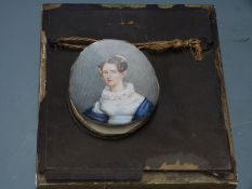 A 19th century portrait miniature on ivory of a lady with a lace collar inscribed verso Mrs C.