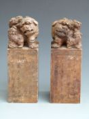 A pair of large Chinese figural scroll weight seals with calligraphy decoration, Dog of Fo finials