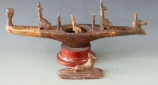 Carved soapstone model of an Egyptian Nile barge or barque with god figures, raised on a circular