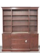 Mahogany astragal glazed breakfront bookcase with three graduated drawers and two cabinets under,
