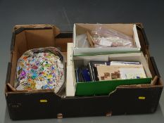 A large quantity of all world stamps, loose and in packets together with a large tin of Holland