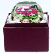 Perthshire faceted glass paperweight with central pink flower with green foliage and cane signed P
