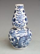 Chinese blue and white double gourd vase with floral and dragon decoration and Kangxi mark to