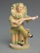 Wade style cellulose jester musician, indistinctly signed verso, H15cm