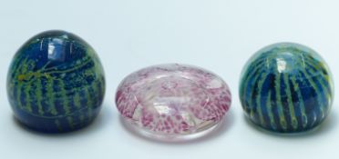 Two Mdina paperweights and a Guernsey glass paperweight, largest 10.2cm in diameter