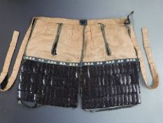 Japanese Edo period haidate yoroi (thigh armour) of lacquered leather construction with silk lining,
