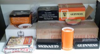 Large quantity of Guinness branded items including 24 glasses, miniature bottles, tea towels,