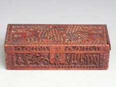 A 19th/20thC carved hardwood Chinese box decorated decorated with court scenes, 24.5 x 9.5 x 7cm