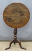 19thC circular tilt top table raised on a turned column and tripod base, diameter 53 x H68cm