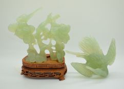 A carved jadeite figure of a bird on a plinth