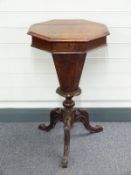 A 19thC walnut octagonal work table with fitted sectional interior raised on a carved tripod base, H